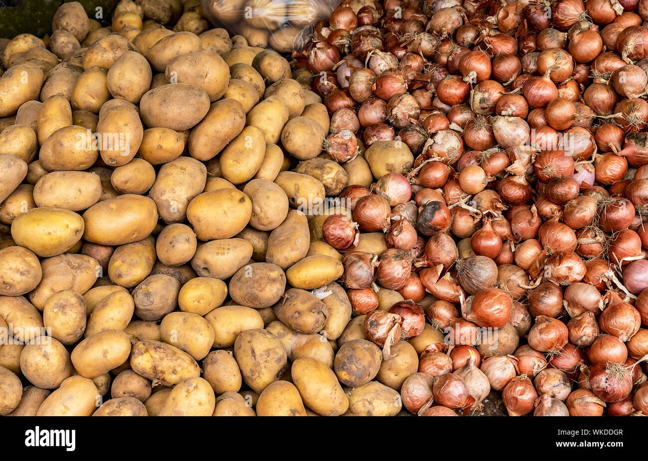 Potatoes and onions in a food market at which local farmers sell