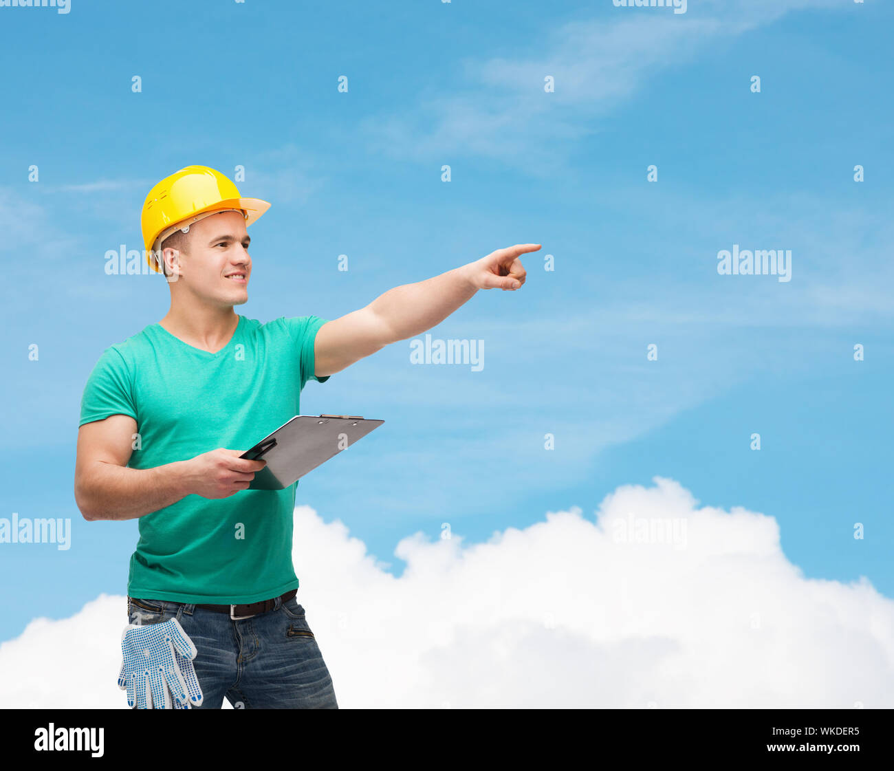 smiling man in helmet with clipboard Stock Photo