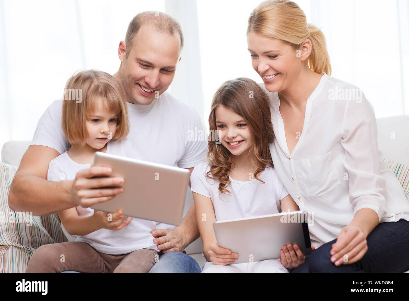 family and two kids with tablet pc computers Stock Photo - Alamy