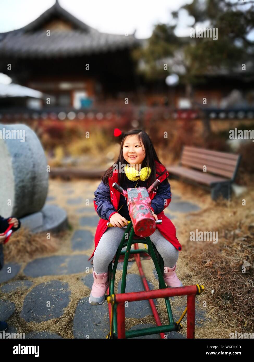 Happy Girl Playing On Outdoor Play Equipment Stock Photo