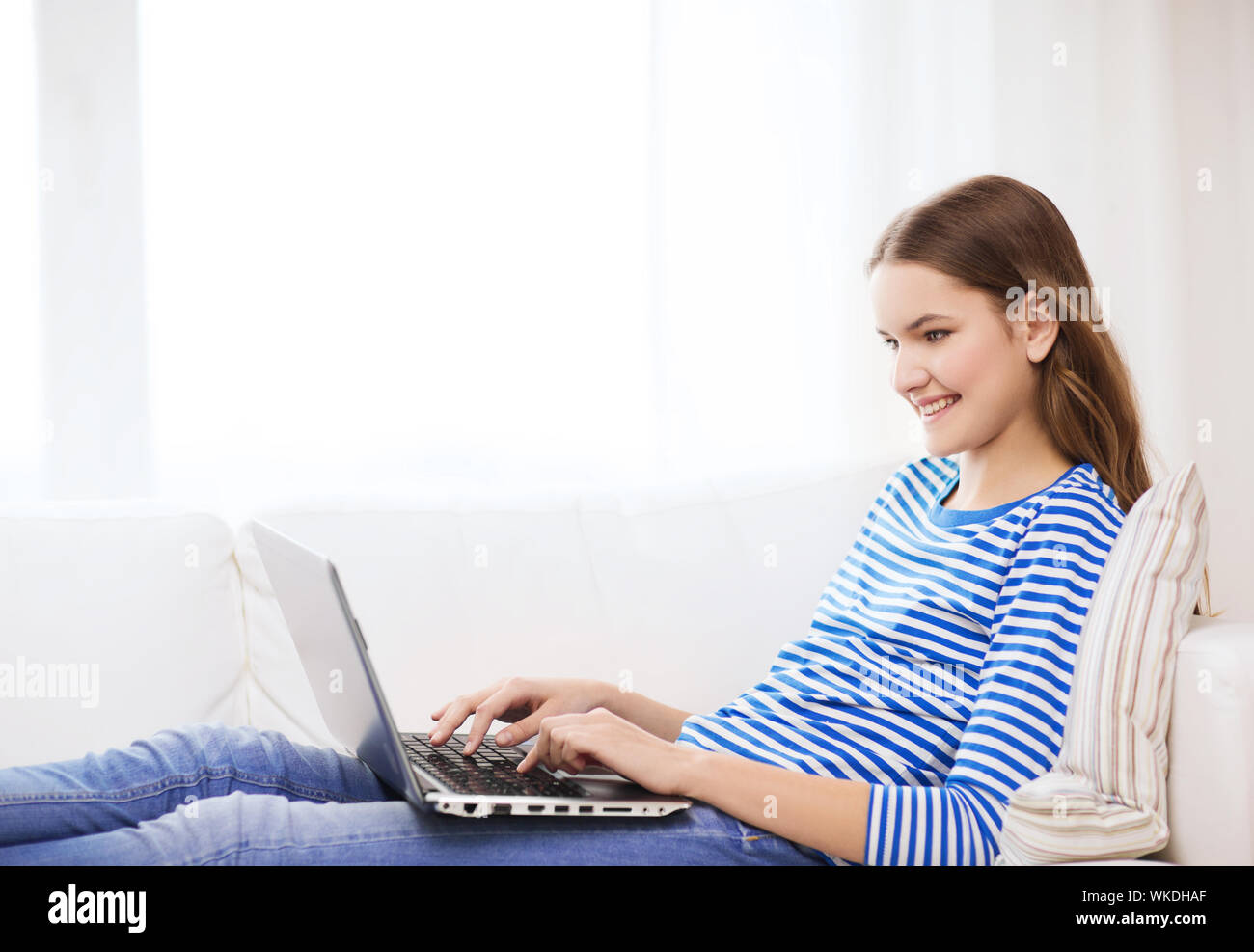 smiling teenage girl with laptop computer at home Stock Photo - Alamy