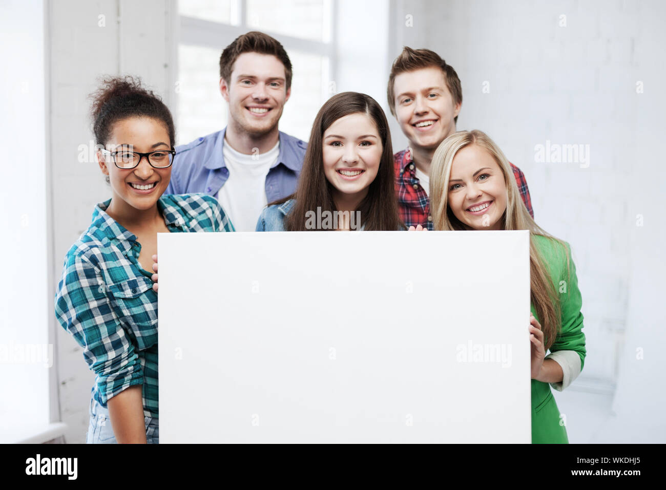 education concept - group of students at school with blank white board ...