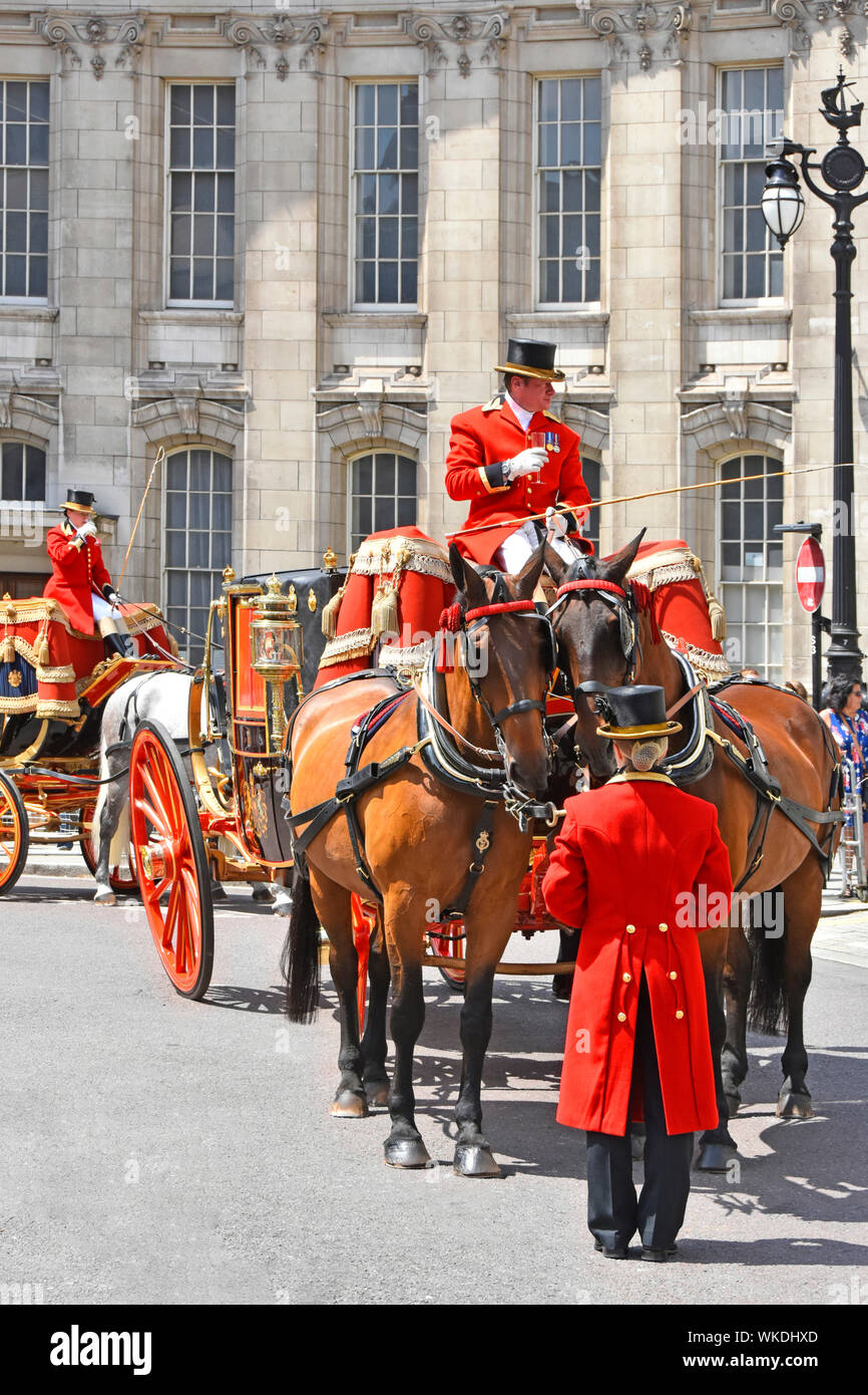 Admiralty Arch with coachman & footman taking refreshments on hot summers day London street scene two horse drawn State Landaus carriages waiting UK Stock Photo