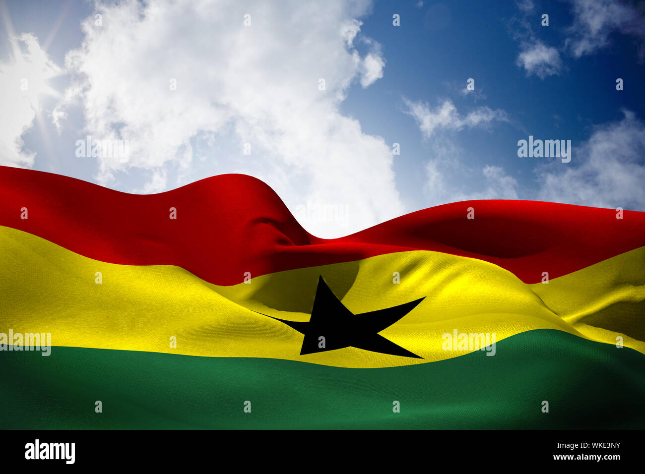 Ghana Flag Waving Against Bright Blue Sky With Clouds Stock Photo - Alamy