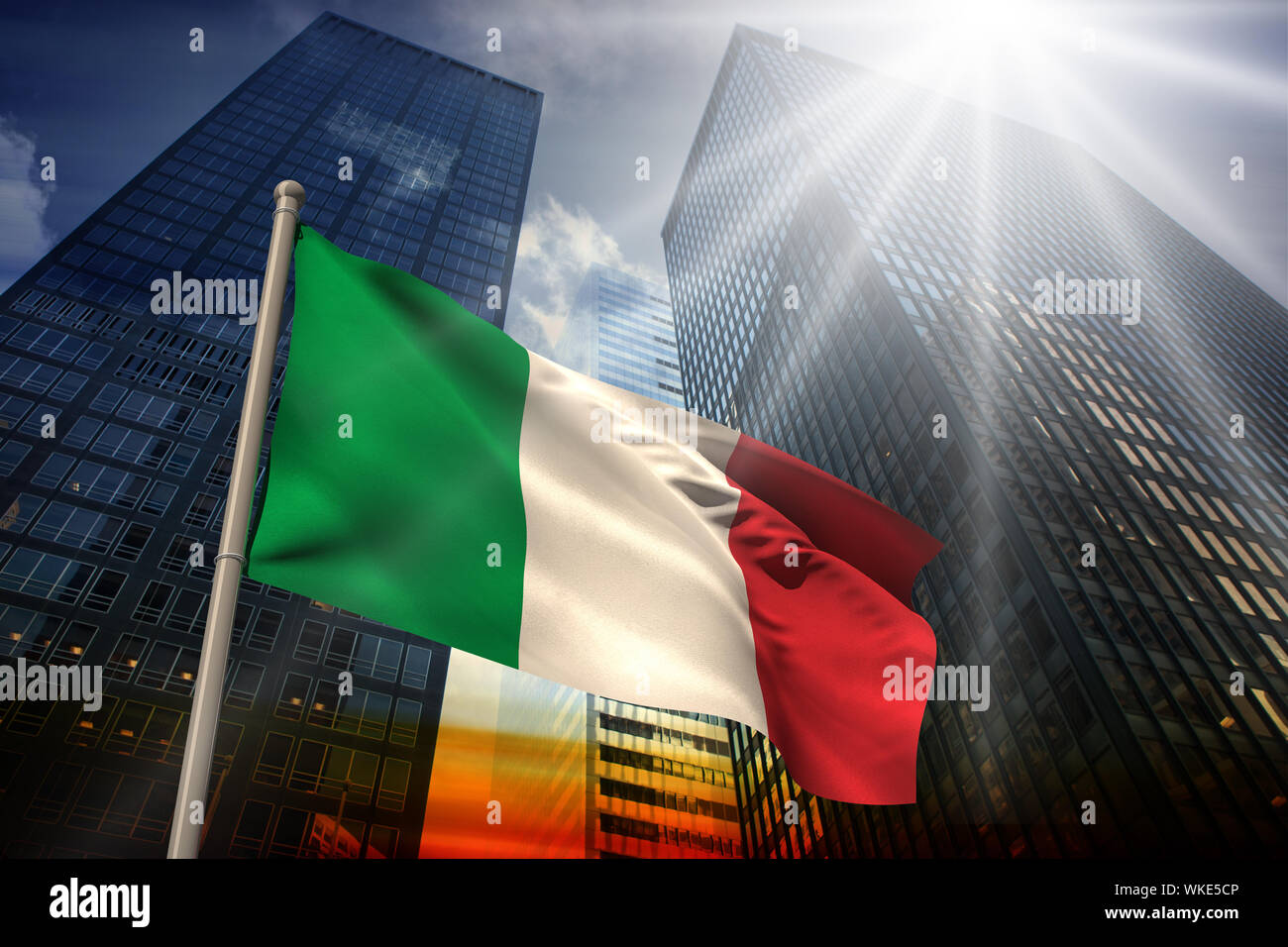 Italy national flag against low angle view of skyscrapers at sunset ...