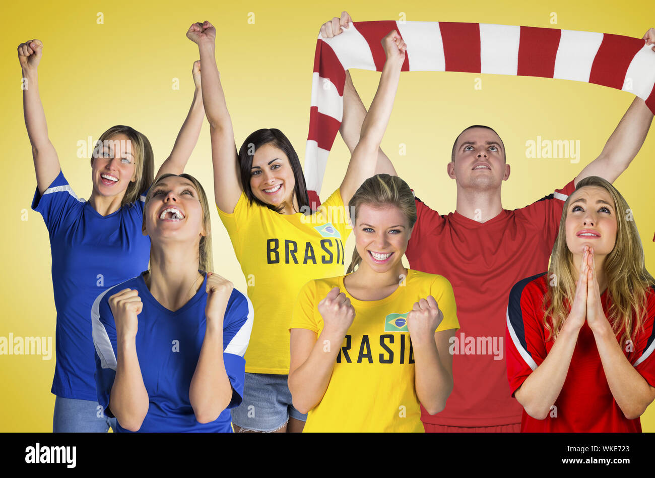 Composite image of football fans against yellow vignette Stock Photo