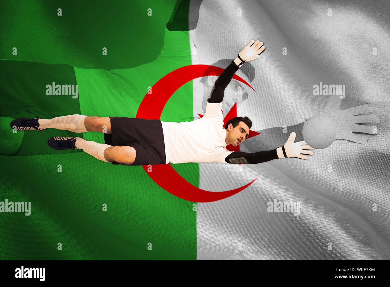 Goalkeeper in white making a save against algerian flag Stock Photo