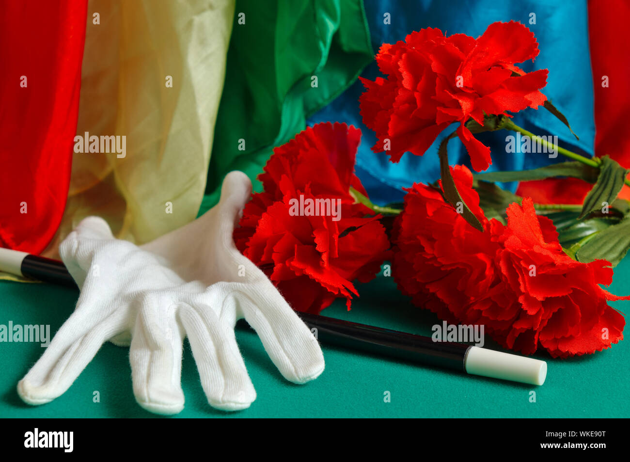 Magic wand, white glove and flowers. Magic and illusion theme Stock Photo