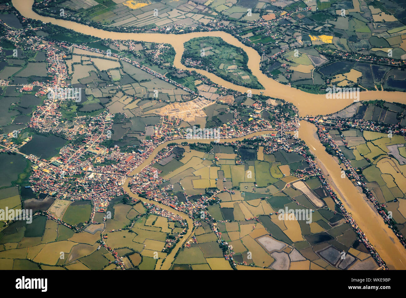 Aerial landscape village countryside in Luzon island with green rice paddy fields and rivers background, Philippines Stock Photo