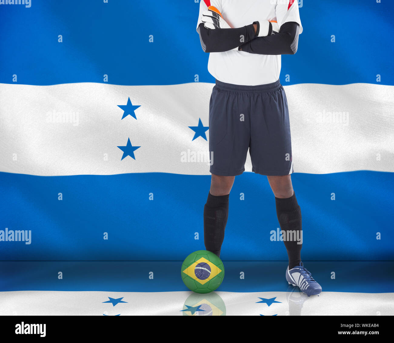 Composite image of goalkeeper in white with ball against digitally generated honduras national flag Stock Photo