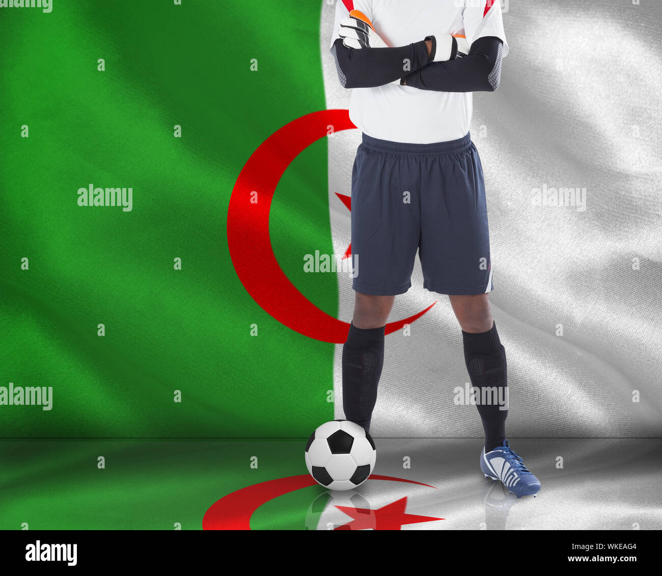 Composite image of goalkeeper in white with ball against algerian flag Stock Photo