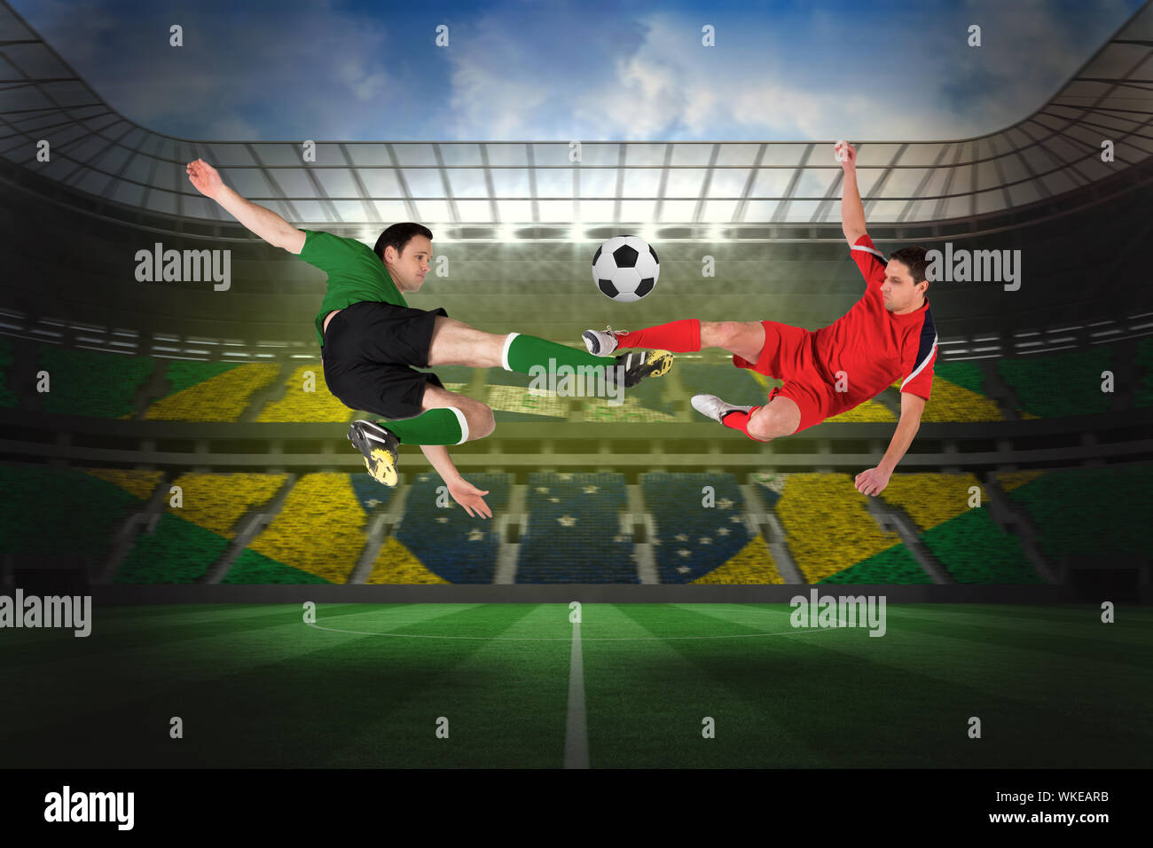 Football players tackling for the ball against large football stadium