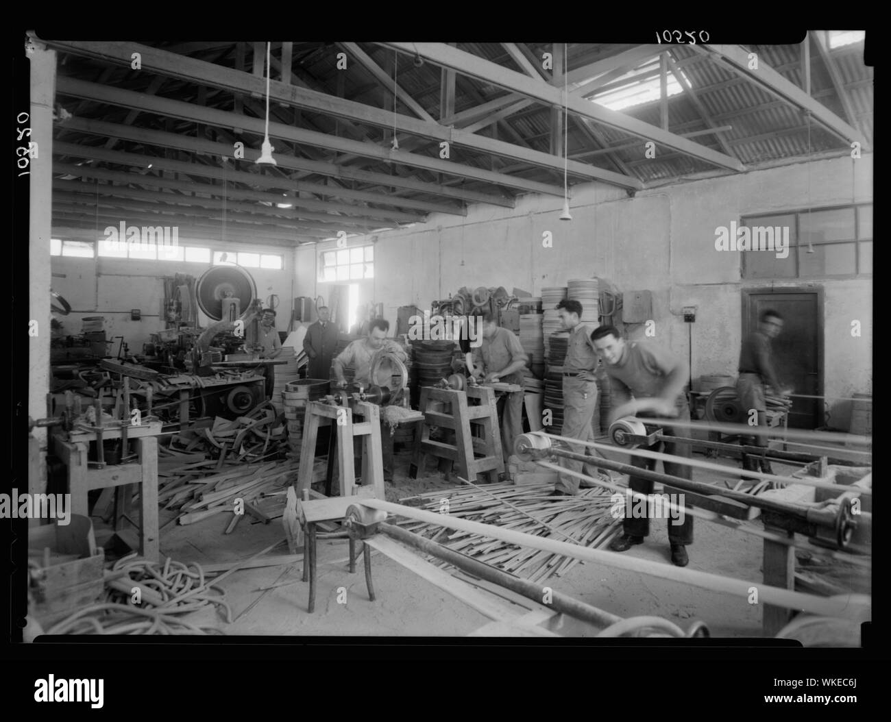Jewish factories in Palestine on Plain of Sharon & along the coast to Haifa. Bent Furniture Factory in Holon settlement. Dressing chair bottoms by machinery Stock Photo
