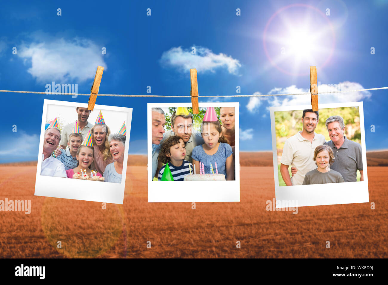 Composite image of instant photos hanging on a line against field and blue sky Stock Photo