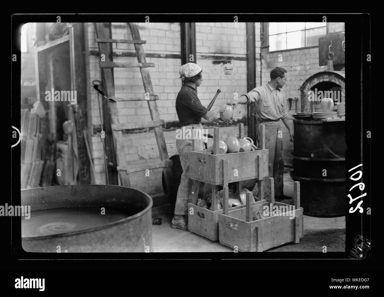 Jewish factories in Palestine on Plain of Sharon & along the coast to Haifa. Haifa. The Kadar Ltd. Ceramics. Burnt fine ceramics being taken from kiln Stock Photo