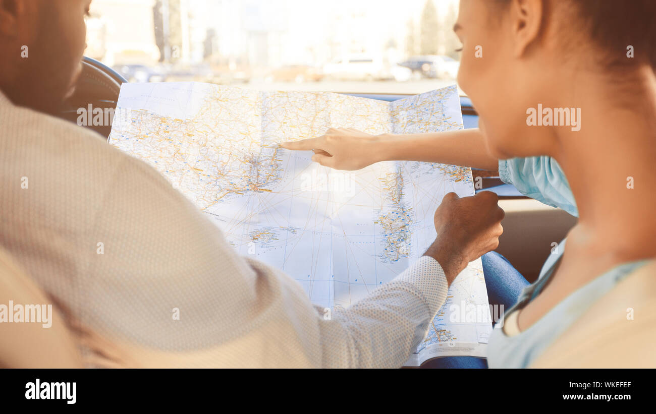 Travel by car. Couple planning route on map Stock Photo - Alamy