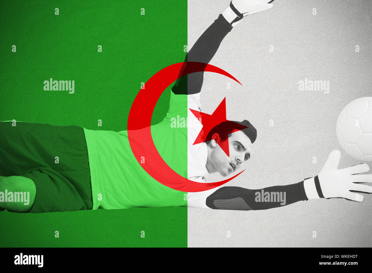 Goalkeeper in white making a save against algeria national flag Stock Photo