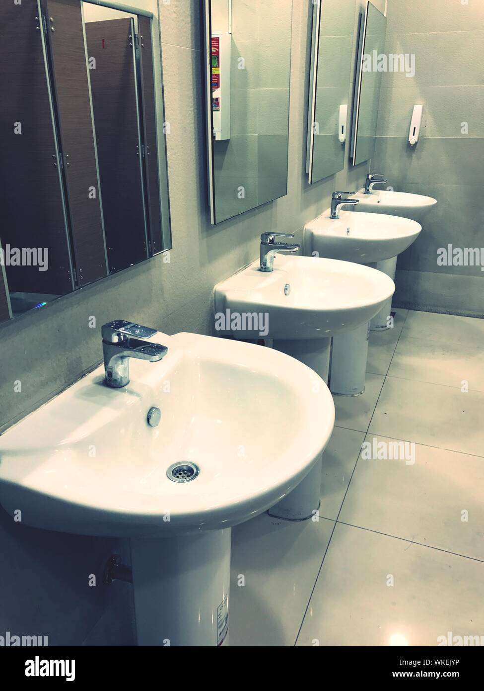 Mirror And Sink In Illuminated Bathroom Stock Photo Alamy