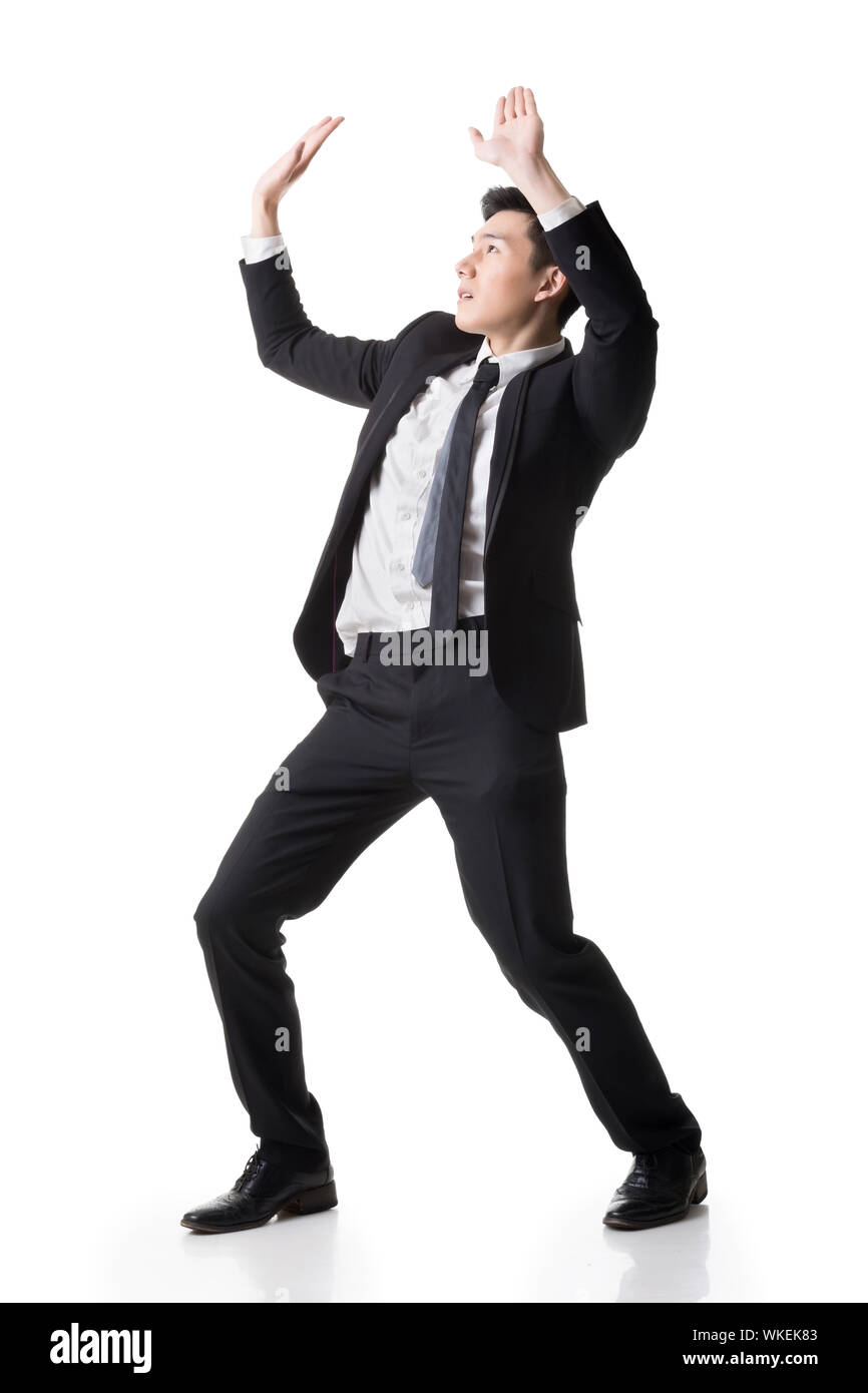 Asian business put hands up against something, full length portrait ...