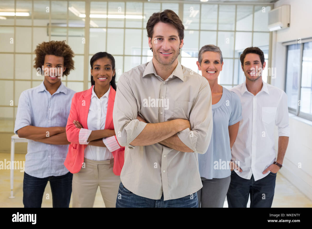 Work management smiling to camera in the office Stock Photo - Alamy