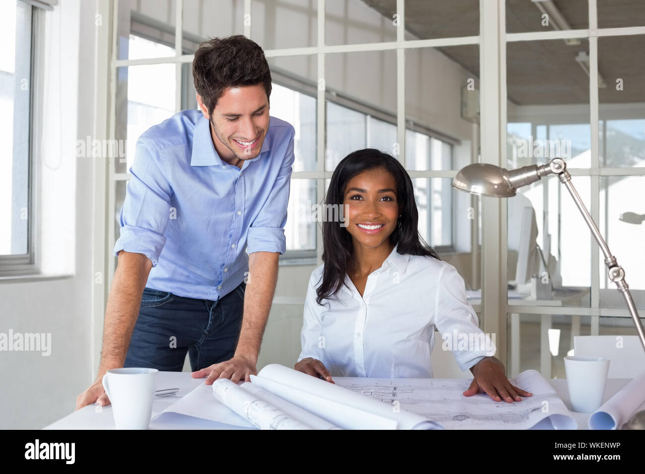 Architects working hard on blueprints in the office Stock Photo