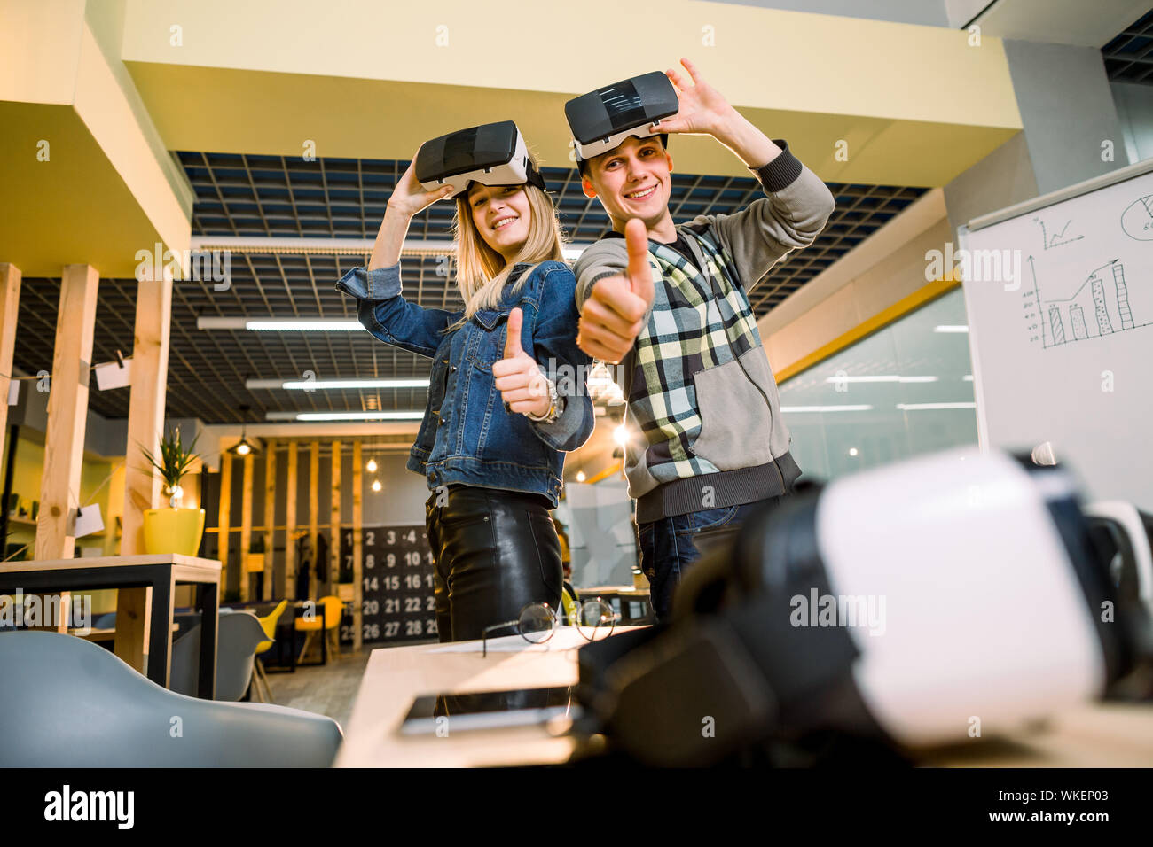 amazed young beautiful couple testing virtual reality 3D video glasses