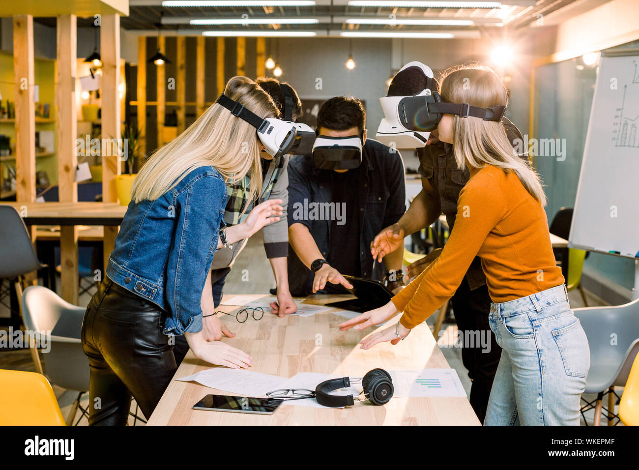 Young people having fun with the new technology vr headset goggles Stock Photo