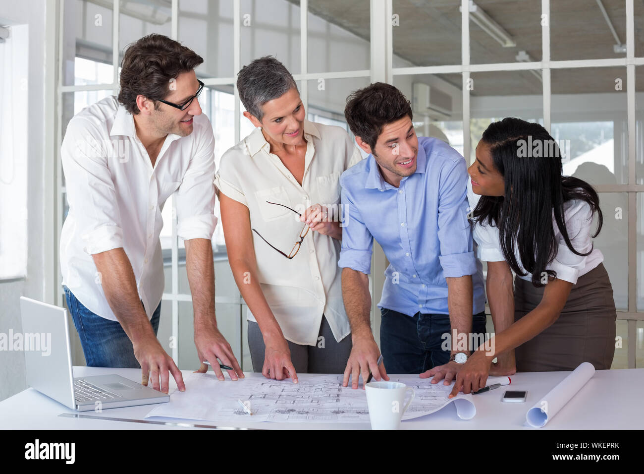 Team architects going over blueprints hi-res stock photography and ...
