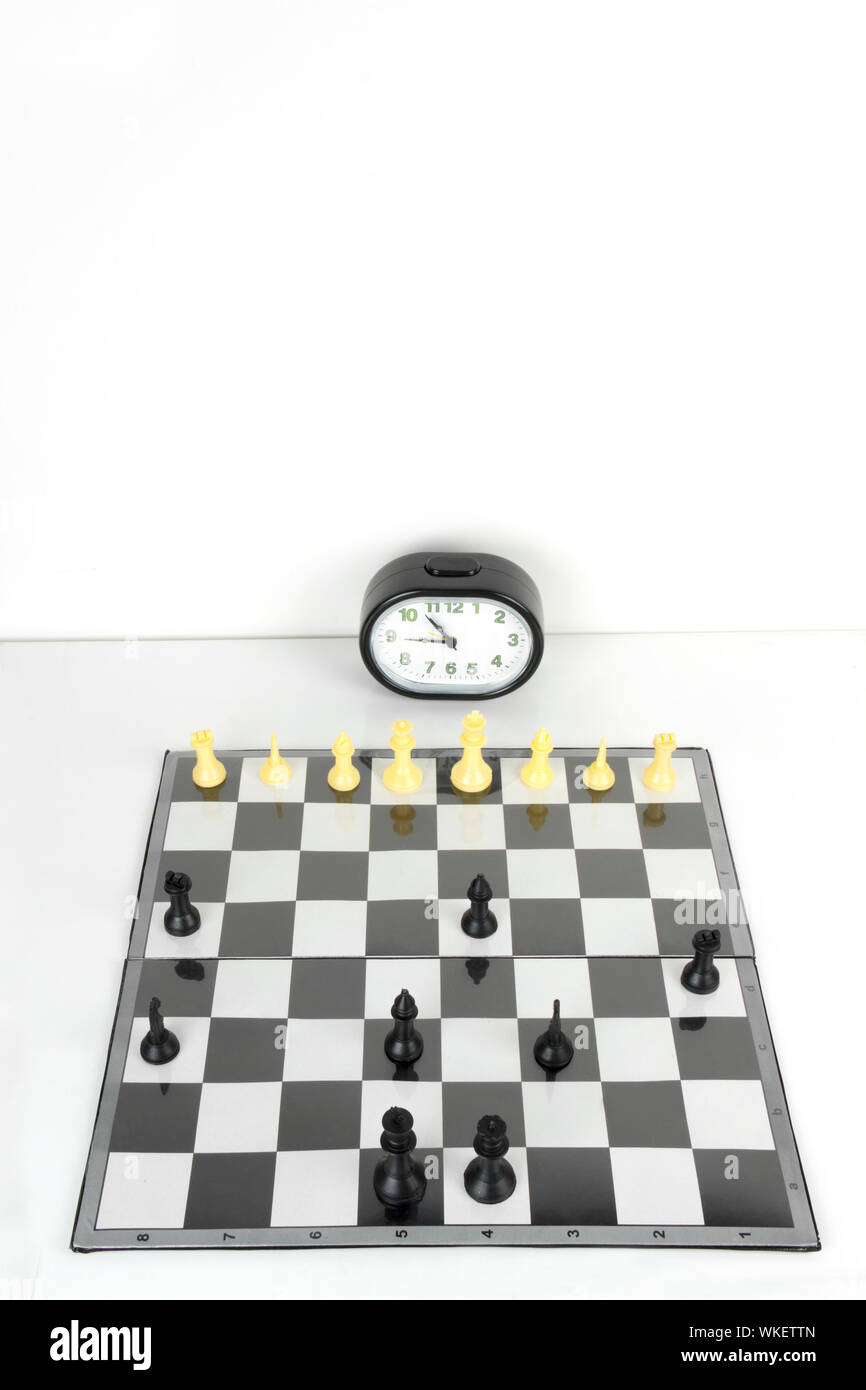 Chess board and timer set up on table Stock Photo Alamy