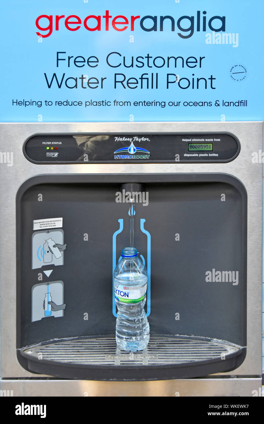 Drinking water bottle auto refilled at fountain free on train station by Greater Anglia help reuse & cut plastic waste pollution Shenfield England UK Stock Photo