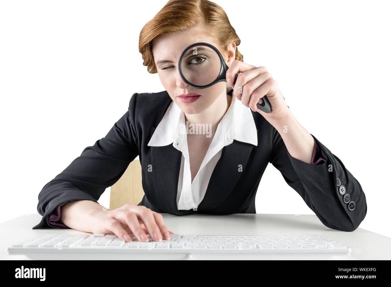 Redhead businesswoman looking through magnifying glass on white ...