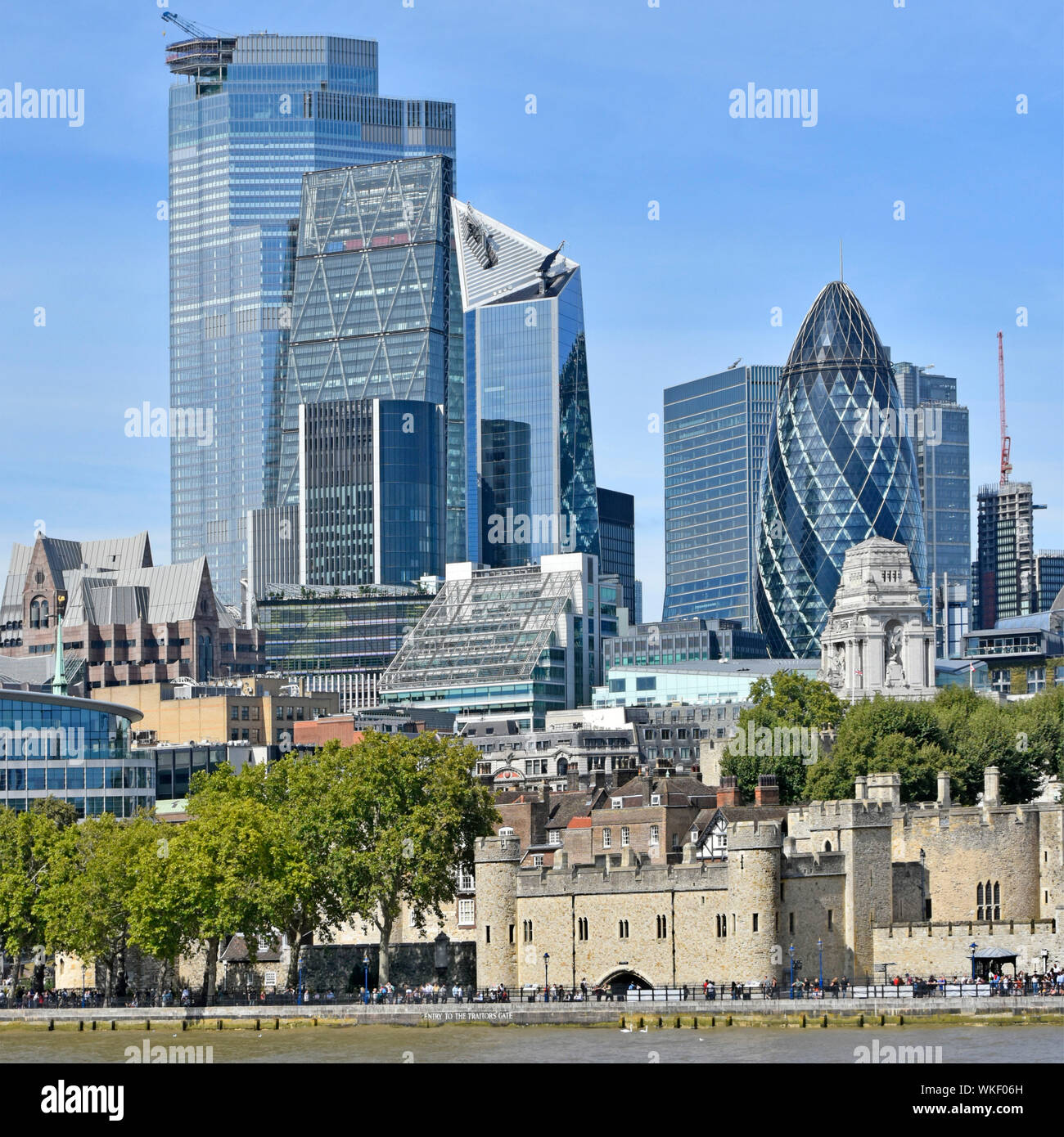 Tower of London dwarfed by skyline & cityscape of skyscraper building construction 2019 in city square mile business district River Thames England UK Stock Photo