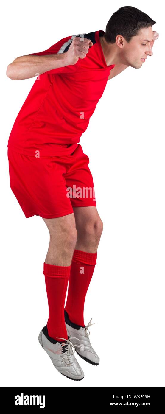 Fit football player jumping up on white background Stock Photo Alamy