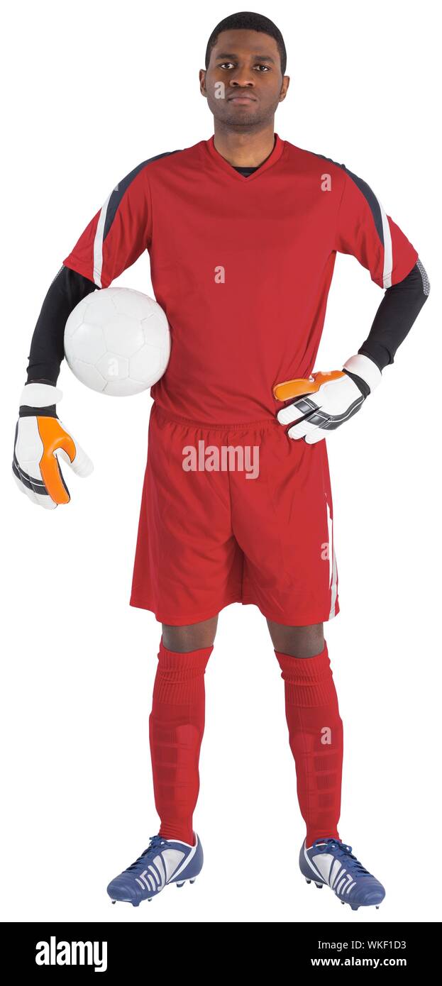 Goalkeeper in red holding the ball on white background Stock Photo