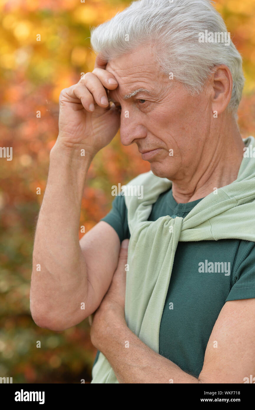 Portrait of a sad senior man posing outdoors Stock Photo