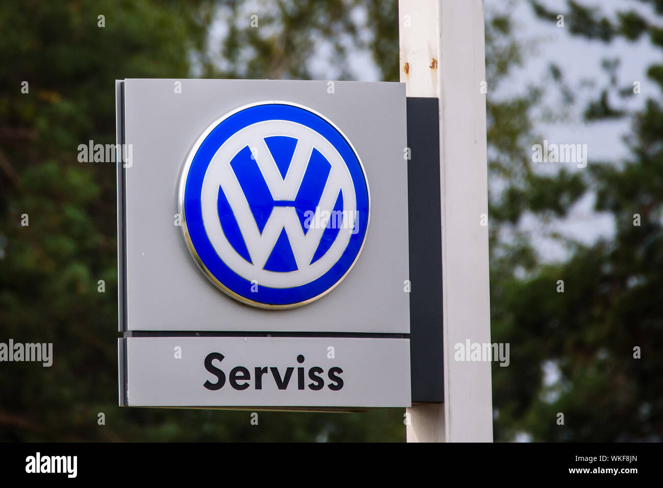 RIGA, LATVIA. 29th August 2019. Volkswagen company logo on facade of  car dealer service. Volkswagen is a german automaker - shortened VW. Stock Photo