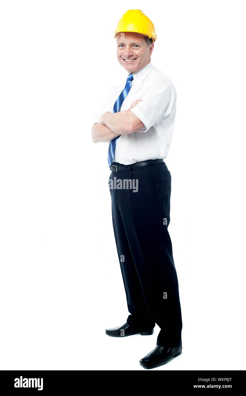 Smiling senior architect posing with ams crossed Stock Photo