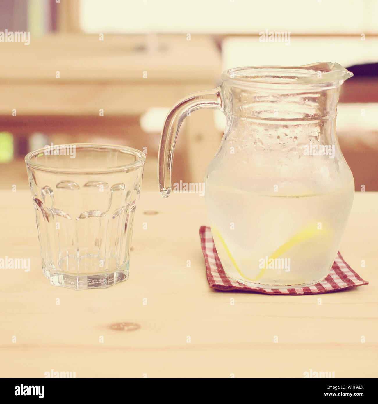 Jar of lemonade with empty glass for summer, retro filter effect Stock Photo Alamy