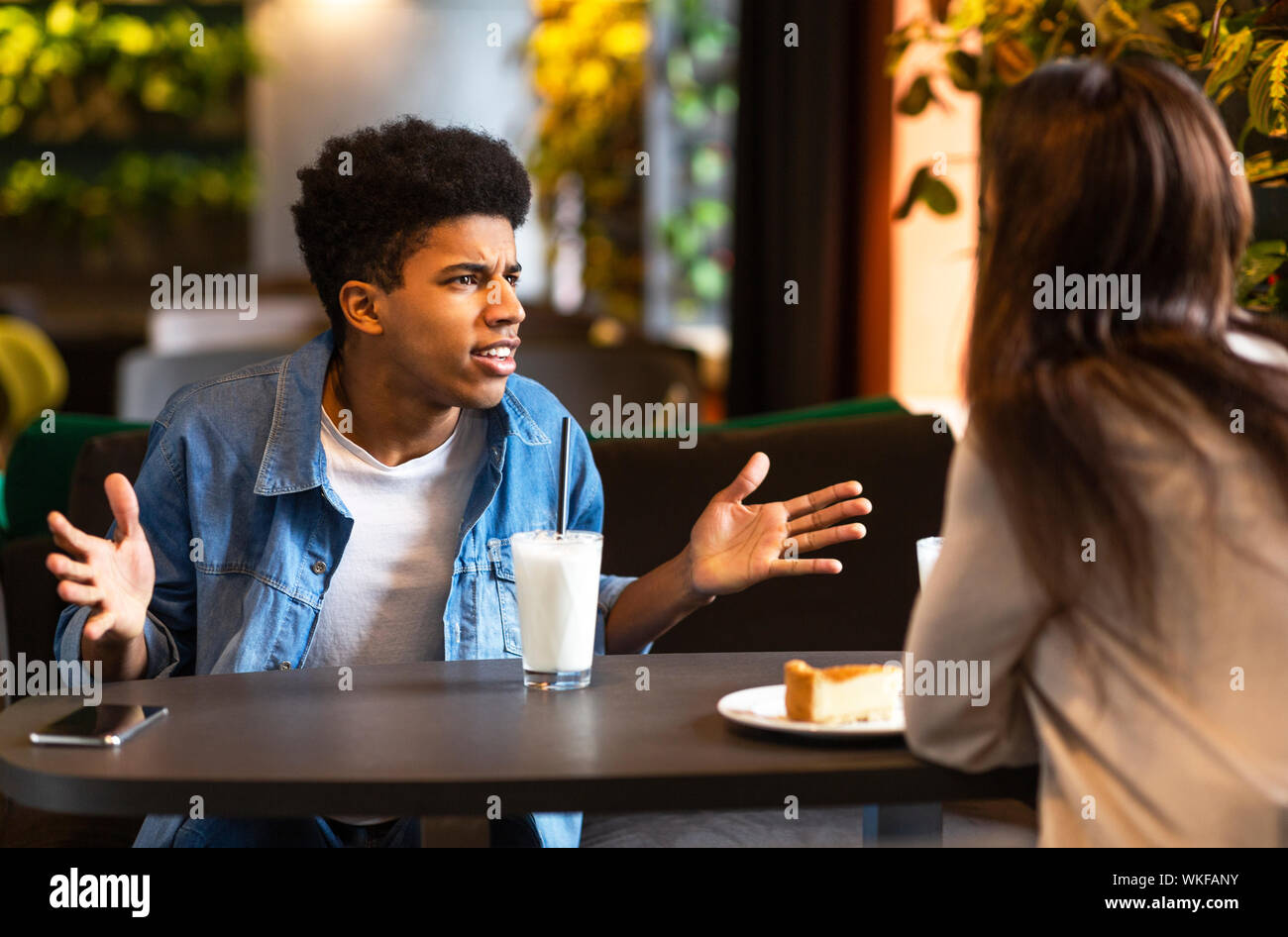 Mad young black guy shouting at his girlfriend Stock Photo