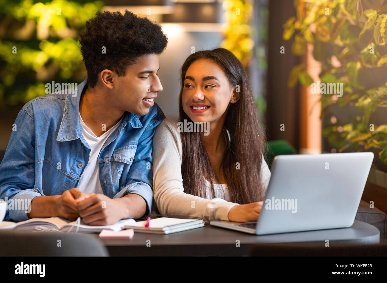 Studying students looking at each other and smiling Stock Photo