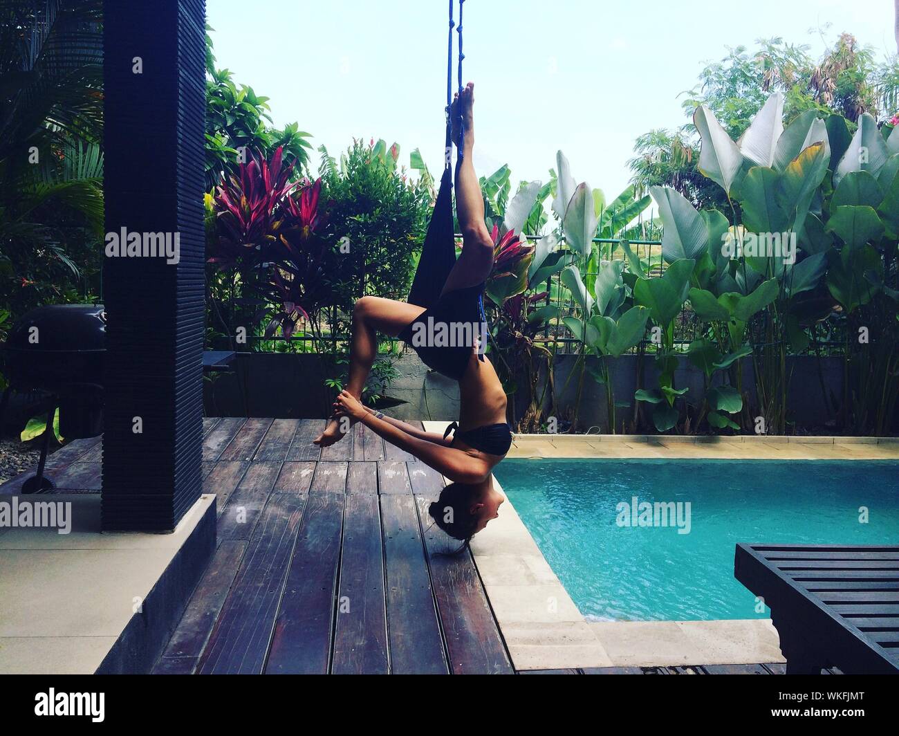 Young women hanging upside down hi-res stock photography and images - Alamy