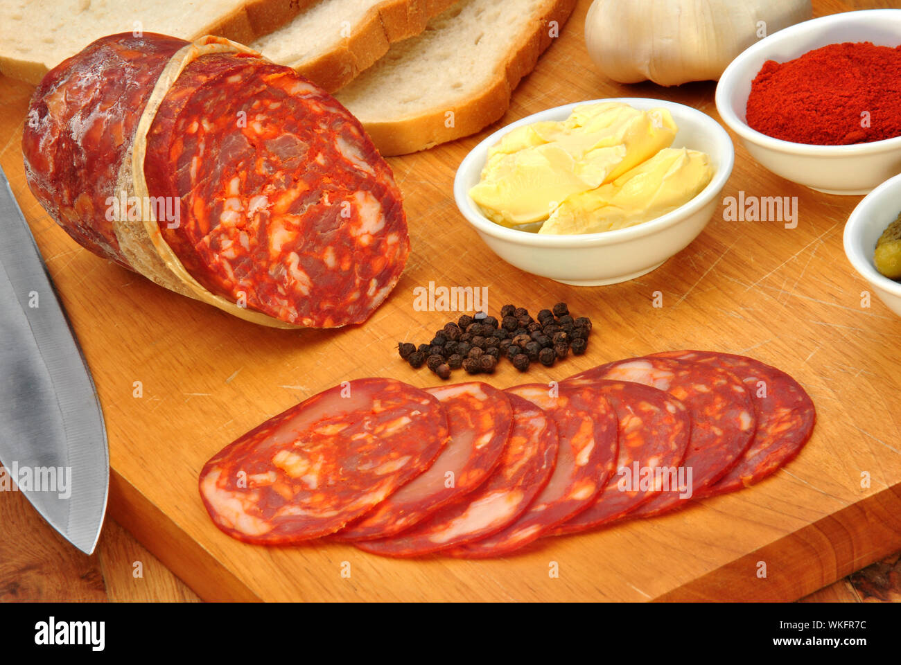 chorizo salami and some slices salami on a timber board Stock Photo Alamy