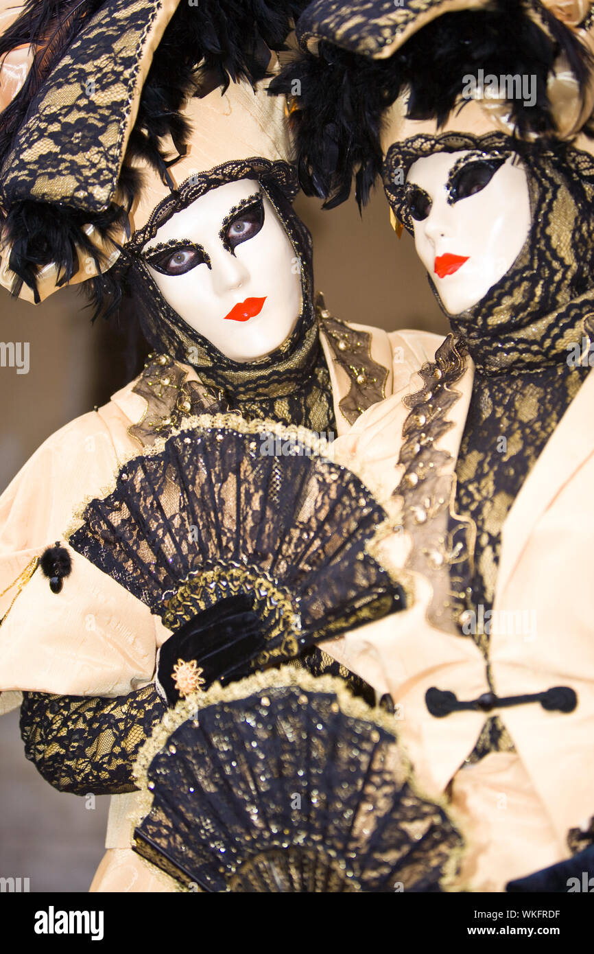 Two people in cream costumes at the Venice Carnival Stock Photo - Alamy