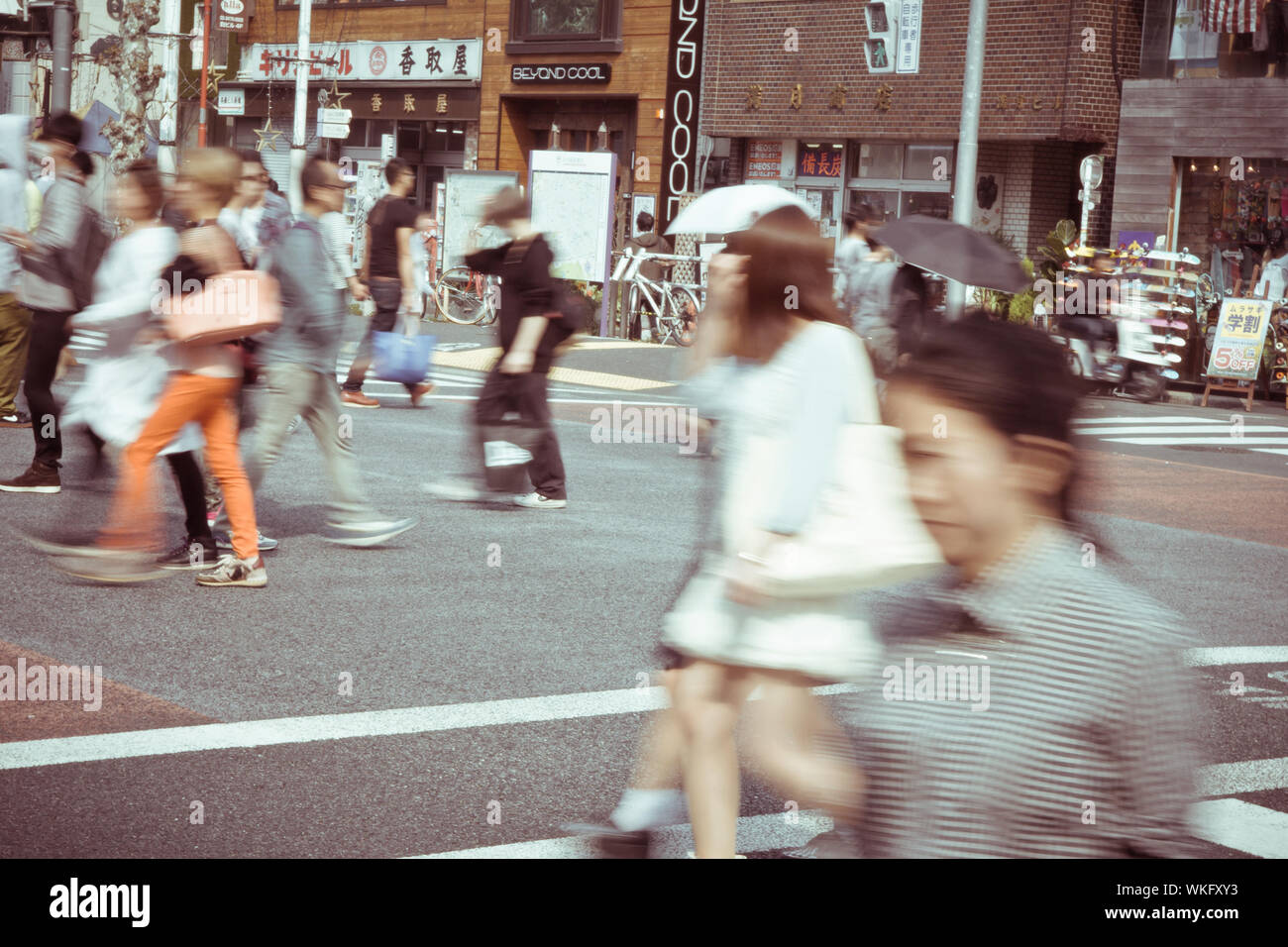 Tourists and business people crossing the street at Harajiku Stock Photo