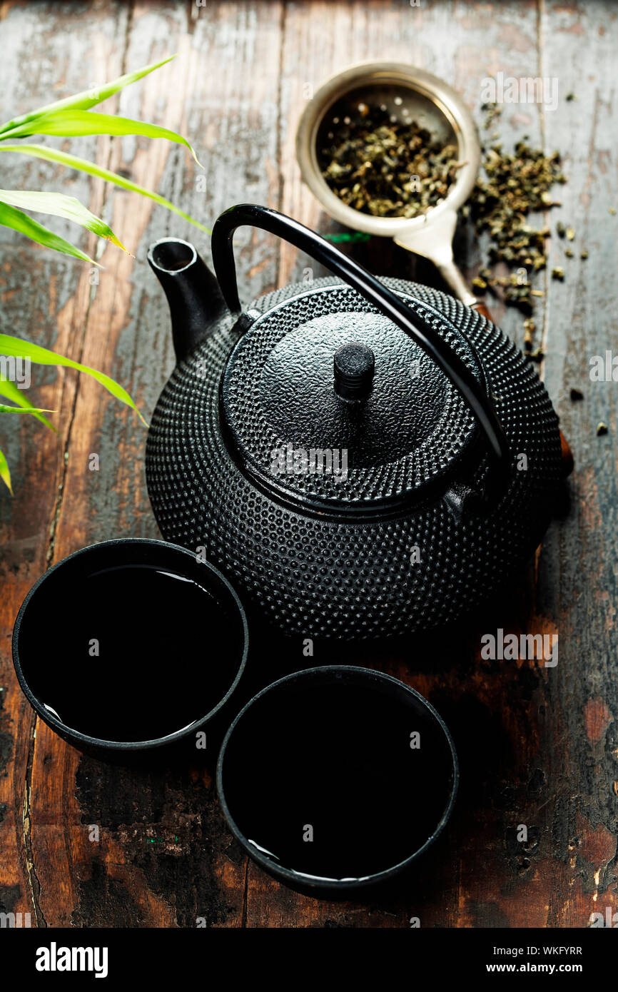 https://c8.alamy.com/comp/WKFYRR/image-of-traditional-eastern-teapot-and-teacups-on-wooden-desk-WKFYRR.jpg