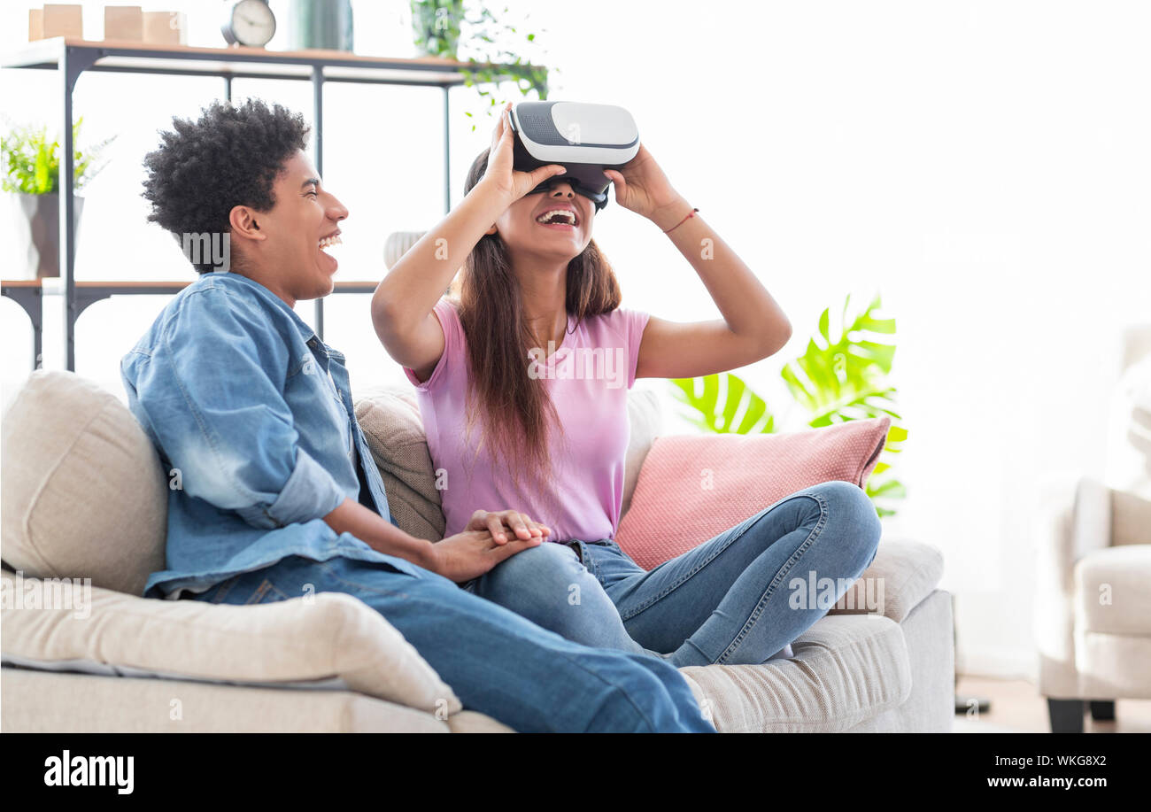 Teenage Couple With Headphone Play Game Online At Home Computer. Stock  Photo, Picture and Royalty Free Image. Image 172632258.