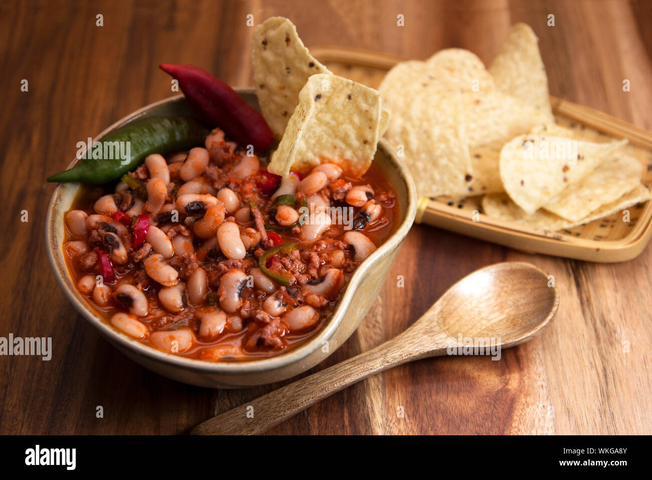 Chili con carne with black eyed beans and nachos Stock Photo Alamy