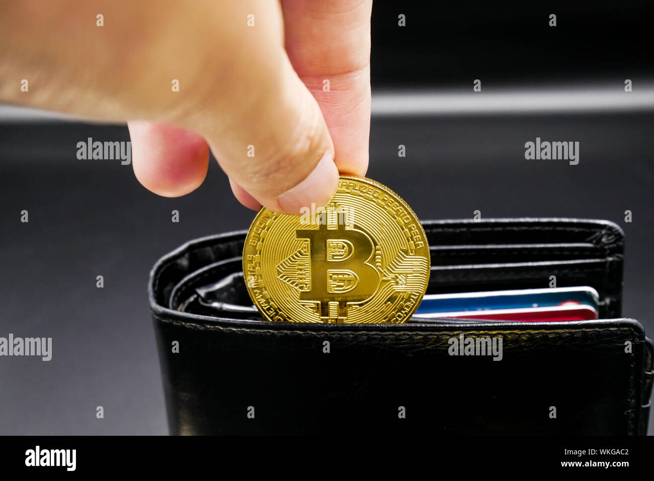 physical version of bitcoin and leather wallet and credit card that is a  new virtual money world cryptocurrency and digital payment system by using  b Stock Photo - Alamy