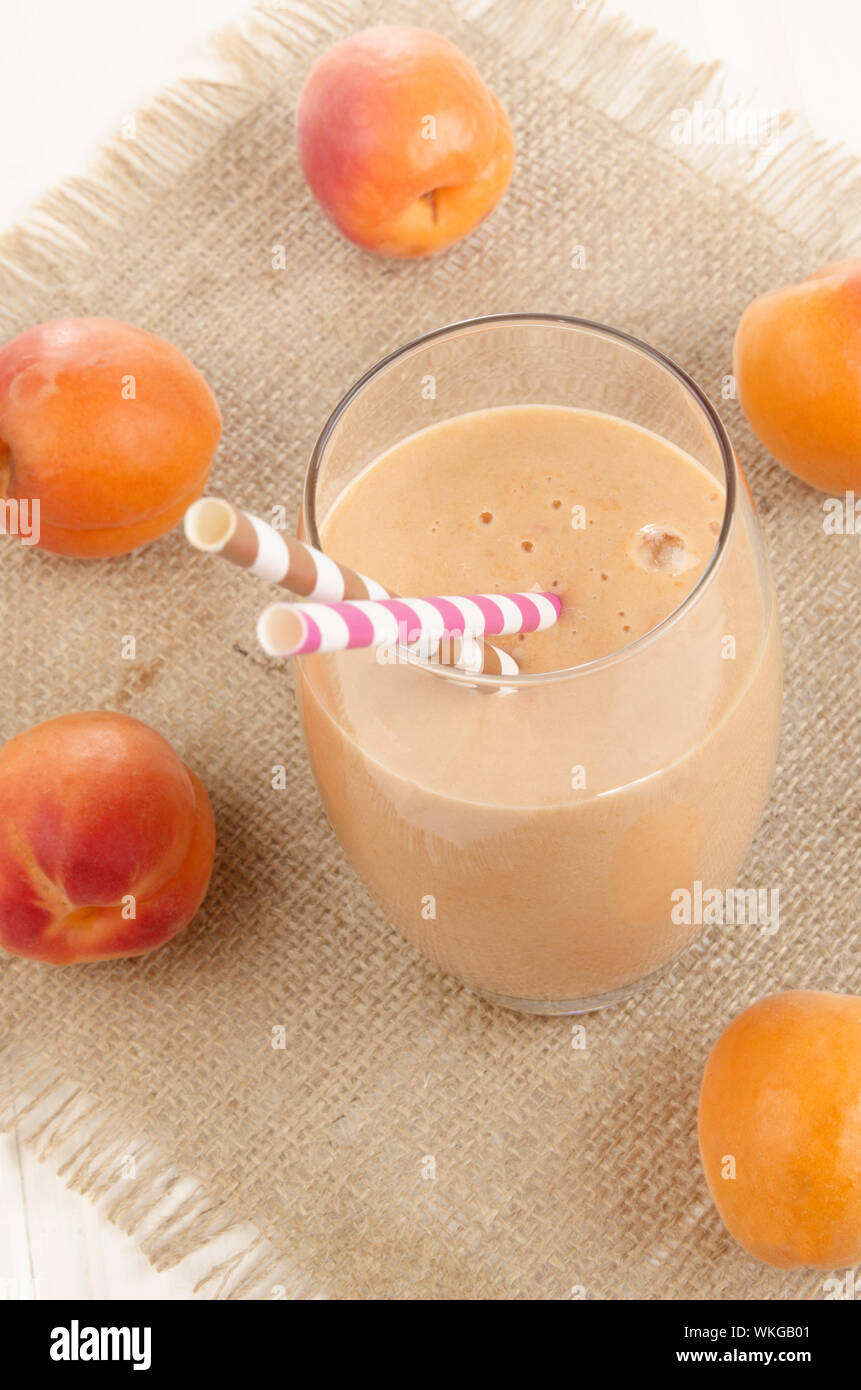milkshake with straw and organic apricots on jute Stock Photo Alamy