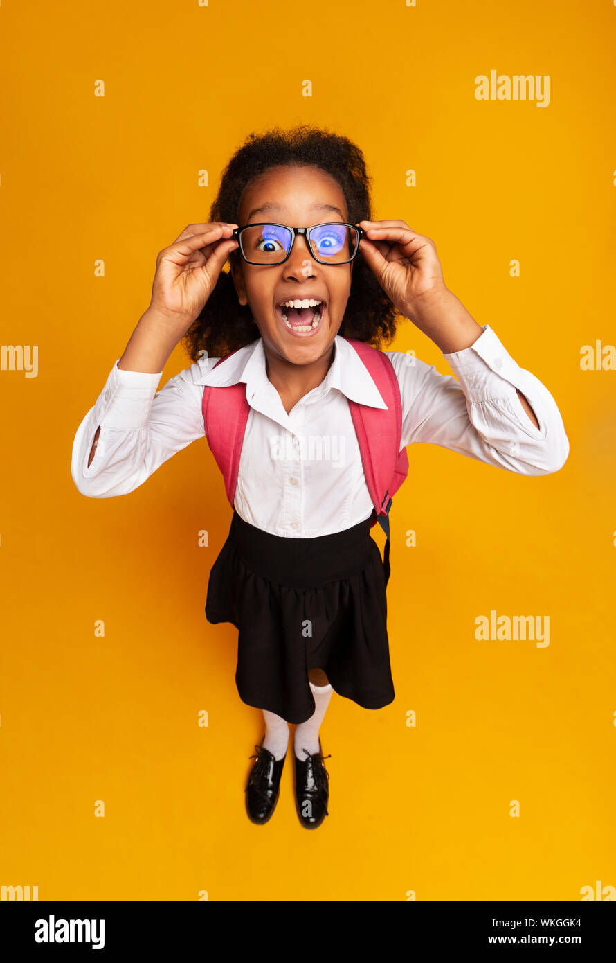 Black Schoolgirl Screaming Looking At Camera, High-Angle Studio Shot Stock Photo